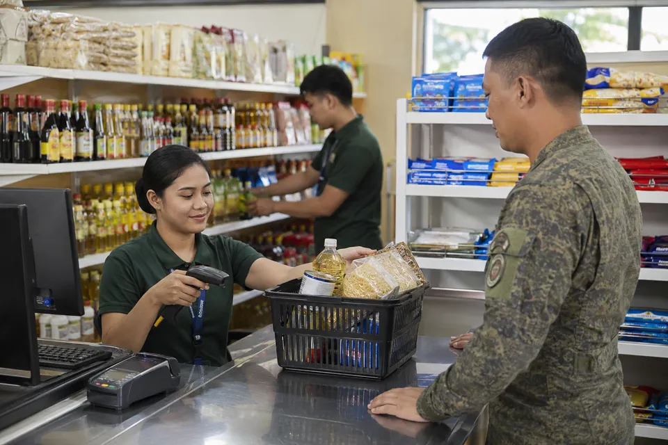 Illustration of a commissary cashier assisting a military customer