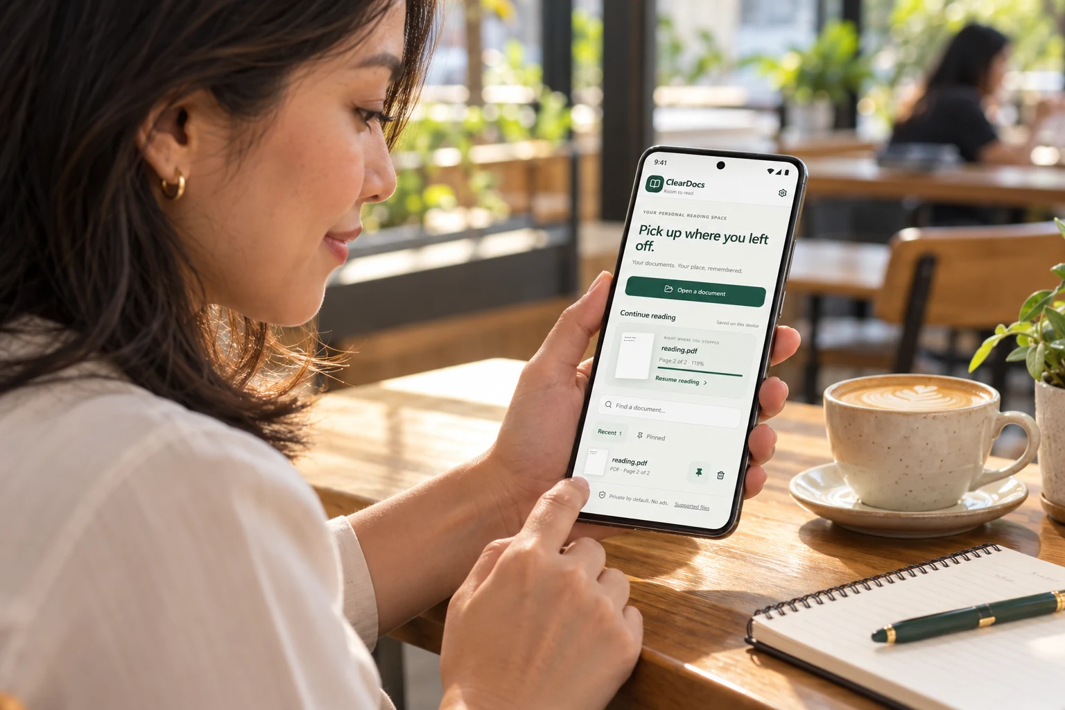 Illustration of a woman reading with ClearDocs on her Android phone in a café